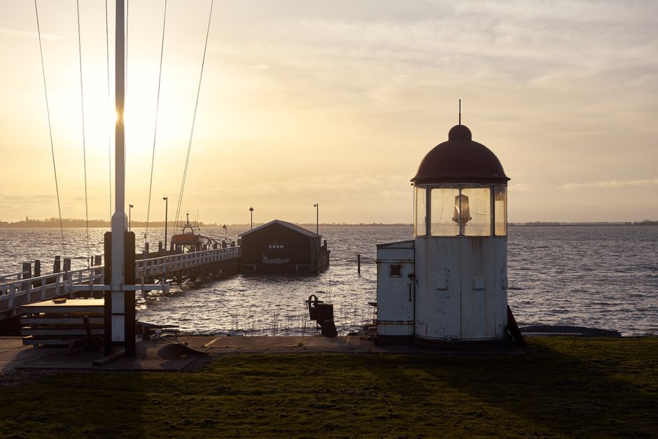 Marken lighthouse and pier at sunset over the IJsselmeer